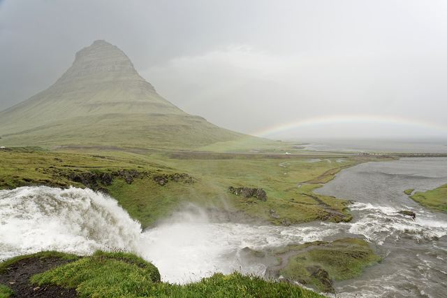 Kirkjufell mountain and Kirkjufellsfoss waterfall on the Snæfellsnes peninsula, Iceland, with a rainbow