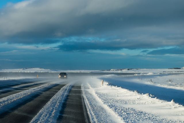 A car on a snowy road in Iceland in winter conditions